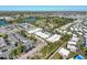 Scenic aerial view of an apartment complex featuring a swimming pool and well-maintained landscaping surrounded by trees at 5509 Fountain Lake Cir # C209, Bradenton, FL 34207