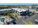 Aerial view of condo buildings with lush landscaping, parking, and a community pool at 5509 Fountain Lake Cir # C209, Bradenton, FL 34207