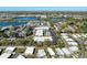An aerial view of a well maintained apartment complex with a swimming pool and ample parking surrounded by several bodies of water at 5509 Fountain Lake Cir # C209, Bradenton, FL 34207