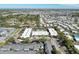 An aerial shot showcases the apartment complex, highlighting its central pool and convenient parking surrounded by trees at 5509 Fountain Lake Cir # C209, Bradenton, FL 34207