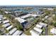 Aerial view of condo buildings with lush landscaping, parking, a community pool and nearby lake at 5509 Fountain Lake Cir # C209, Bradenton, FL 34207