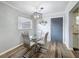 Dining area features a modern light fixture and a glass table, complemented by updated flooring at 5509 Fountain Lake Cir # C209, Bradenton, FL 34207