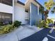 Building exterior showcasing manicured landscaping, covered walkways, and nearby parking at 5509 Fountain Lake Cir # C209, Bradenton, FL 34207