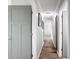 Hallway with wood floors, neutral paint, and white trim providing access to bedrooms and living areas at 5509 Fountain Lake Cir # C209, Bradenton, FL 34207