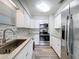 Bright kitchen features stainless steel appliances, granite countertops, and updated cabinetry at 5509 Fountain Lake Cir # C209, Bradenton, FL 34207