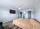 Bright main bedroom with wood floors, tv, and an en-suite bathroom providing a private retreat at 5509 Fountain Lake Cir # C209, Bradenton, FL 34207