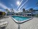 Community pool featuring a paved deck, lounge chairs, and lush tropical landscaping at 5509 Fountain Lake Cir # C209, Bradenton, FL 34207