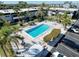 Overhead image of the outdoor pool shows lounge chairs and greenery surrounding condos and parking spaces at 5509 Fountain Lake Cir # C209, Bradenton, FL 34207
