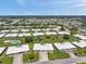 Expansive aerial view showing multiple homes, lush lawns, and the community's inviting pool at 6524 11Th W Ave # 5611, Bradenton, FL 34209