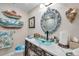 Charming bathroom with a glass vessel sink, decorative mirror, and unique seashell accents at 6524 11Th W Ave # 5611, Bradenton, FL 34209