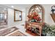 Elegant entryway with tile floors, decorative mirror, and ornate console table with floral arrangement at 6524 11Th W Ave # 5611, Bradenton, FL 34209