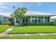 Attractive home exterior featuring a well-maintained yard, mature trees, and inviting curb appeal at 6524 11Th W Ave # 5611, Bradenton, FL 34209