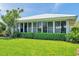 Exterior view of the home, showcasing the sunroom addition and landscaping at 6524 11Th W Ave # 5611, Bradenton, FL 34209