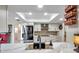 Modern kitchen features quartz counters, stainless appliances, mosaic backsplash and ample lighting at 6524 11Th W Ave # 5611, Bradenton, FL 34209