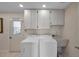 Functional laundry room featuring built-in cabinets, a utility sink, and easy access to the outside at 6524 11Th W Ave # 5611, Bradenton, FL 34209