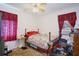 Bedroom with a bed, windows, and flooring at 6812 E 21St Ave, Tampa, FL 33619