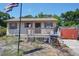 Charming single-story home with a cozy front porch and well-lit exterior, perfect for relaxing outdoors at 6812 E 21St Ave, Tampa, FL 33619