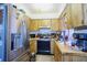 Functional kitchen featuring stainless steel refrigerator, ample cabinetry, and essential appliances at 6812 E 21St Ave, Tampa, FL 33619