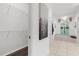Bathroom featuring neutral tile, walk-in closet, tub under a large window, and tasteful decorations at 710 N River Rd, Venice, FL 34293