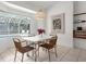 Bright dining area featuring a pool view and a stylish light fixture at 710 N River Rd, Venice, FL 34293