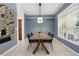 Stylish dining room with a unique light fixture and blue painted walls at 710 N River Rd, Venice, FL 34293