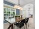 Dining room featuring modern decor and natural light from large windows at 710 N River Rd, Venice, FL 34293