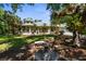 Beautiful home featuring a large, landscaped front yard and inviting wrap-around porch at 710 N River Rd, Venice, FL 34293