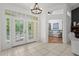 Bright foyer featuring double doors and views into the living room at 710 N River Rd, Venice, FL 34293
