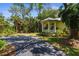 Inviting cottage-style home featuring a bright yellow exterior and a cozy front porch at 710 N River Rd, Venice, FL 34293