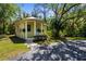Charming cottage-style home with a cheerful yellow exterior and inviting front porch at 710 N River Rd, Venice, FL 34293