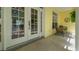 Inviting front porch with seating area, complemented by bright exterior paint and natural light at 710 N River Rd, Venice, FL 34293