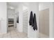 Hallway leading to the main bedroom and bathroom, featuring tile floor and neutral color scheme at 710 N River Rd, Venice, FL 34293