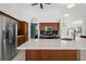 Open concept kitchen with stainless steel appliances and a large center island at 710 N River Rd, Venice, FL 34293