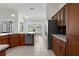 Well-lit kitchen with wooden cabinets, stainless steel appliances, and a view to the dining room at 710 N River Rd, Venice, FL 34293
