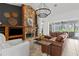 Comfortable living room featuring a striking stone fireplace, stylish decor, and ample seating at 710 N River Rd, Venice, FL 34293
