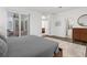 Bright main bedroom with sliding glass doors, hardwood floors, and neutral color palette at 710 N River Rd, Venice, FL 34293