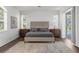 Spacious main bedroom with a king size bed, a bright, airy feel, and wood-look floors at 710 N River Rd, Venice, FL 34293
