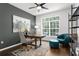 Stylish home office with hardwood floors, a large window, decorative rug, and ample seating at 710 N River Rd, Venice, FL 34293