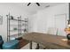 Bright office space features a large desk, hardwood floors, shelving and blue accent chair at 710 N River Rd, Venice, FL 34293