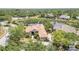Aerial view showcases a beautiful home with mature trees, a private driveway, and a serene, lush landscape at 7303 Westminster Ct, University Park, FL 34201