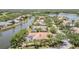 Aerial view of the home showcasing landscaping, pool, and canal access at 7303 Westminster Ct, University Park, FL 34201