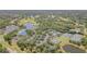 A birds-eye view of the community, highlighting the tennis courts, golf course, and lakes at 7303 Westminster Ct, University Park, FL 34201