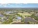 Aerial view of community featuring golf course, pools, and recreational facilities at 7303 Westminster Ct, University Park, FL 34201