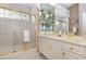 Well lit bathroom featuring a glass shower door, single sink vanity with plenty of storage at 7303 Westminster Ct, University Park, FL 34201