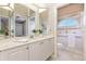 A bright bathroom features a glass enclosed shower, with a single sink vanity at 7303 Westminster Ct, University Park, FL 34201