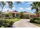 Beautiful exterior elevation view of a home with a large front yard and a circular driveway at 7303 Westminster Ct, University Park, FL 34201