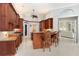 Modern kitchen features custom wood cabinetry, an island with bar seating, and stainless steel appliances at 7303 Westminster Ct, University Park, FL 34201