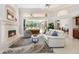 Bright living room with a fireplace, neutral decor, and sliding glass doors to the lanai at 7303 Westminster Ct, University Park, FL 34201