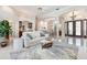 Spacious living room featuring high ceilings, elegant columns, and an open floor plan at 7303 Westminster Ct, University Park, FL 34201