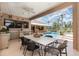 Spacious outdoor kitchen and dining area with a ceiling fan, offering a perfect spot for entertaining by the pool at 7303 Westminster Ct, University Park, FL 34201